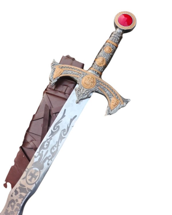 Decorative sword with ornate handle and red gemstone on a white background